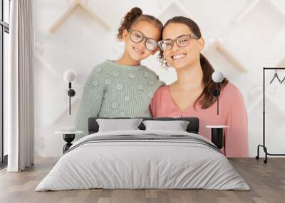 Portrait, mother and girl with glasses for vision, hug and smile being happy for eye care, loving and eye exam together. Eyewear, mama and daughter embrace, eyesight and healthcare for strong eyes. Wall mural