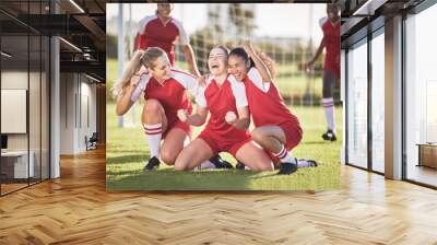 Celebrate, winning and success female football players with fist pump and hurray expression. Soccer team, girls or friends on a field cheering with victory sign, celebrating win in a sports match Wall mural