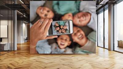 Family selfie, phone face and hand of man with technology with grandparents and children, smile while relax and happy on living room floor. Parents, kids and elderly people taking photo on tech Wall mural