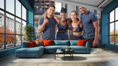 Fitness, exercise and diverse accountability group standing together and looking happy after training at gym. Portrait of friends enjoying their membership at a health and wellness facility Wall mural