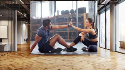 Gym wellness couple high five for success or good exercise and well done gesture for reaching fitness goal. Active trainer and client woman celebrating a great workout, training or exercising session Wall mural