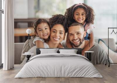 Happy, smile and portrait of an interracial family sitting on a sofa in the living room at home. Happiness, love and adoptive parents bonding, embracing and relaxing with their children in the lounge Wall mural