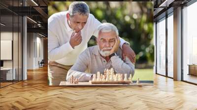 Nothing tests your mental muscle like chess. Shot of two senior men playing a game of chess outside. Wall mural