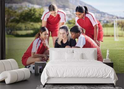 Soccer, sports and woman athlete players planning, discussing and briefing game plan by coach on digital tablet. Teamwork, training and speaking female footballers at stadium field with goal posts Wall mural