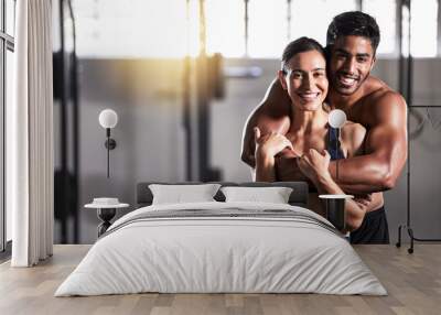 Strong, active and wellness couple looking fit and healthy after workout training session in a gym. Young sexy, attractive and athletic boyfriend and girlfriend hugging after reaching fitness goal Wall mural