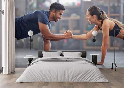 Support, teamwork and fitness couple doing workout training, challenging exercise for endurance, strength and stamina in a gym. Active, fit man and woman giving support and motivation during pushup Wall mural