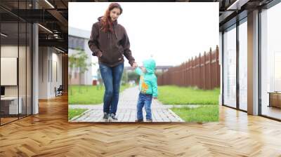 A small child on a walk with mother Wall mural