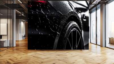 Aesthetic Photo of a Black car Covered in Washing Soap and Foam. Close Up Shot of Foam Dripping from Car's Rear Wheel Arch onto the Electric Car's Tyre and Rim Wall mural