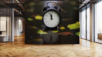 alarm clock on autumn leaves on natural background Wall mural