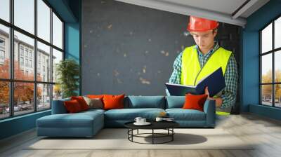 Asian man in protective helmet and construction waistcoat Wall mural