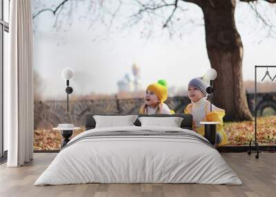 Children walk in the autumn park Wall mural