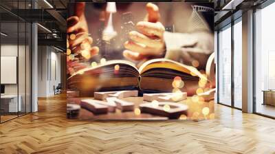 Close up of an unrecognizable man holding a book standing against a evening city panorama. Mock up, toned image, double exposure Wall mural