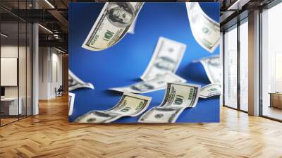 Green dollar bills on a blue background. 100 dollar bills close up. The concept of wealth and success. Money flies in the air. Wall mural