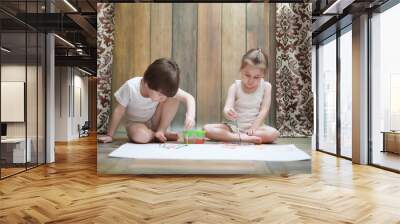 Little children paint on a large sheet of paper Wall mural