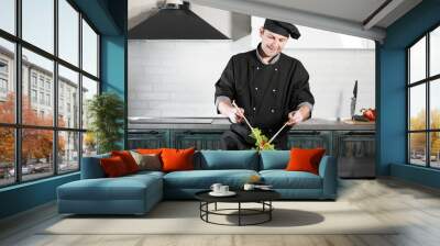 Man cook preparing food at the kitchen of vegetables Wall mural