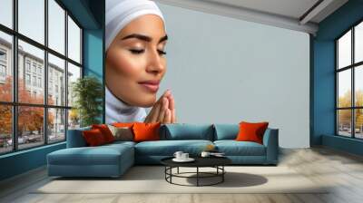 Peaceful Woman in Hijab Meditating with Closed Eyes Against Grey Background Wall mural