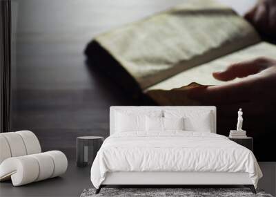 Reading religious literature. Open book. Man reads bible or Koran. Wall mural