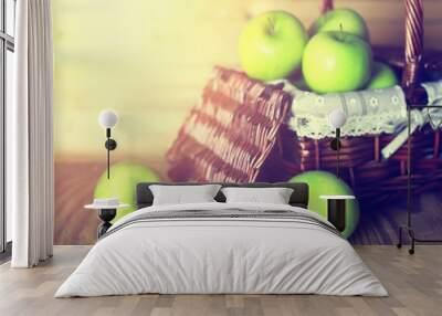 sunlight green apple in a basket wooden background Wall mural