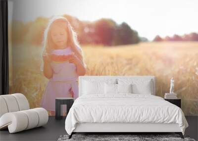 Young girl in a wheat field. Summer landscape and a girl on a na Wall mural