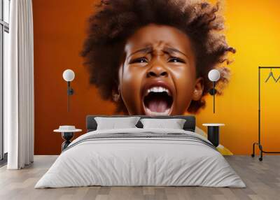 black child boy screaming on yellow isolated background Wall mural