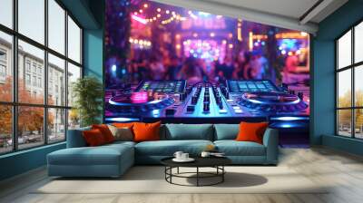 console DJ controller mixer in booth on table in nightclub at night party against background of people dancing under spotlights Wall mural