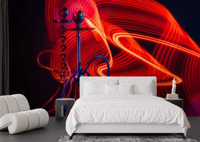 hookahs with shisha charcoal with red neon lighting on the table Wall mural