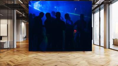 silhouettes of people dancing in nightclub on dance floor at party Wall mural