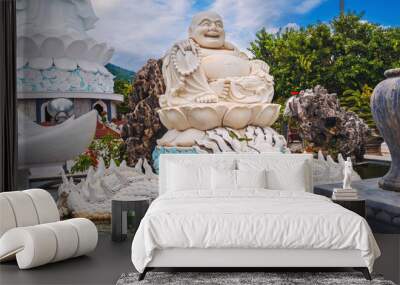 White statue of the happy Buddhist god Hotei at Linh Ung Pagoda in Da Nang in Vietnam in Asia Wall mural