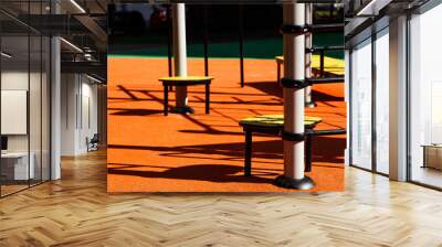 Exploring the vibrant playground under the warm sun, where children create memories and laughter thrives Wall mural