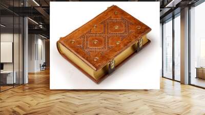 Bright brown aged leather book with decorative pattern on the front cover, gilded paper edges and two closure clasps. Wall mural