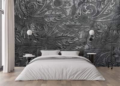 Embossed shiny black leather with the floral motif Wall mural