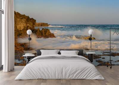 Sea evening landscape with a rocky shore and waves Wall mural