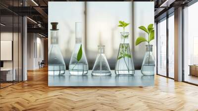 collection of laboratory glassware filled with water and plants, symbolizing green hydrogen production and sustainability. scene reflects innovation and environmental consciousness Wall mural