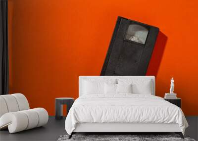 A videotape without a cover on an orange background. Wall mural