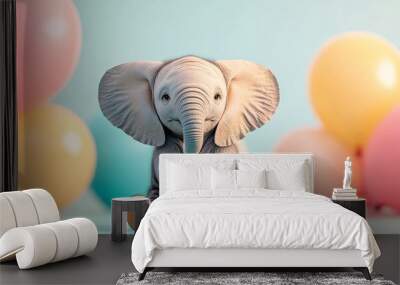 Cute baby elephant toy sitting with colorful balloons in background Wall mural