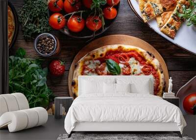 Delicious pizzas and ingredients lying on rustic wooden table Wall mural