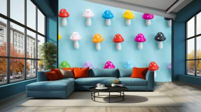 Figures in the form of colored mushrooms on a blue background Wall mural