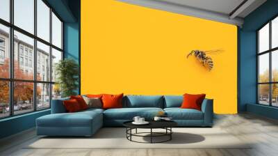 Golden honeybee or bee isolated on the yellow background Wall mural