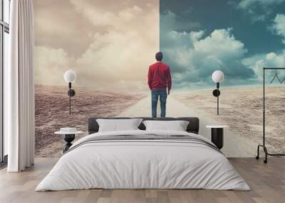 Man standing at fork in the road choosing between sunny or stormy sky Wall mural