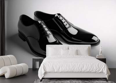 Pair of black leather elegant shoes standing on white background Wall mural