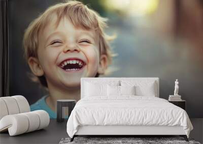 Portrait of adorable toddler boy laughing outdoors Wall mural