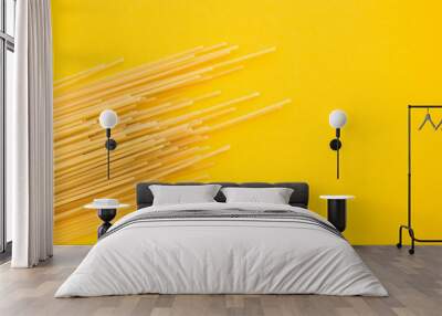 Spaghetti pasta on yellow background, from above Wall mural