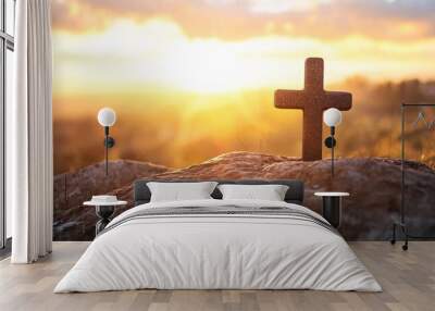 Stone cross on a rocky hill with a stunning sunset in the distance Wall mural