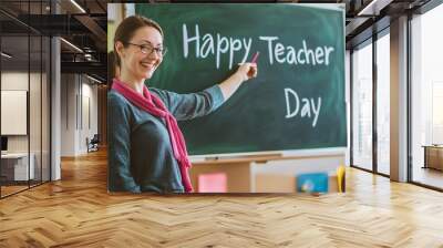 Teacher writing happy teacher day on blackboard in classroom Wall mural