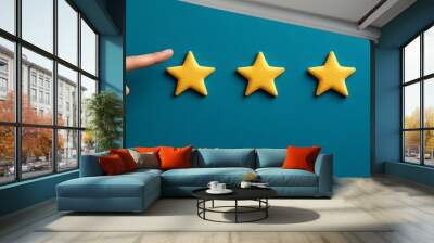 Woman hand pointing five star shape yellow rating on blue background Wall mural