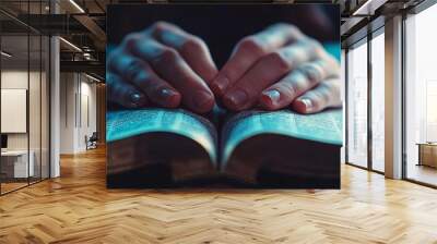 Woman praying holding hands on bible in church with blue tint Wall mural