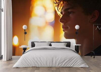 Young man deep in thought, bathed in the warm glow of stained glass windows inside a church Wall mural