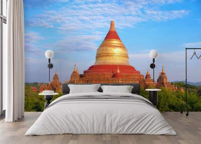 Blue sky above temples surrounded by green vegetation in old Bagan, Myanmar. Wall mural