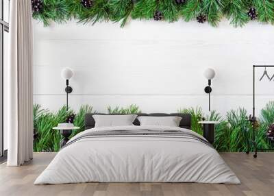 Сhristmas garland with undecorated pure green natural fir branches with cones on white wooden background Wall mural