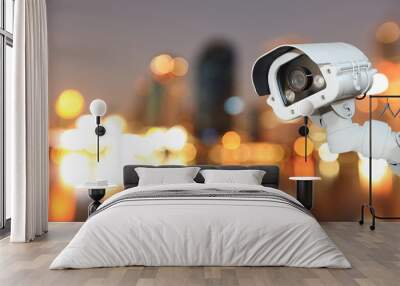 CCTV with bokeh blurring city in night background. Wall mural